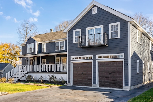 view of front facade with a balcony, a porch, and a garage