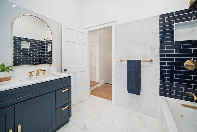 bathroom featuring vanity and tiled shower / bath