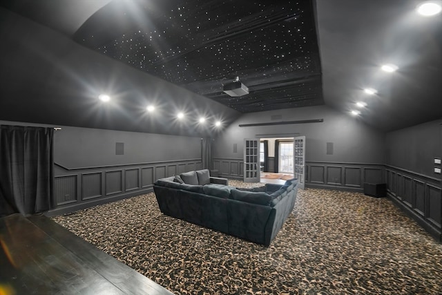 cinema with wood-type flooring and lofted ceiling