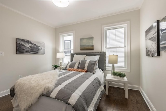 bedroom featuring crown molding, baseboards, and wood finished floors