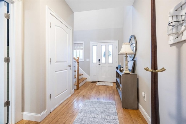 foyer with light wood finished floors and baseboards