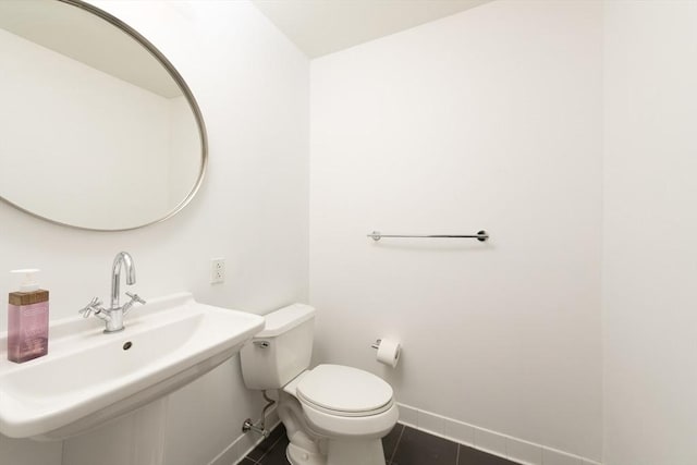 bathroom with sink, tile patterned floors, and toilet