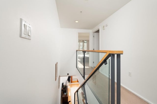 corridor featuring light colored carpet