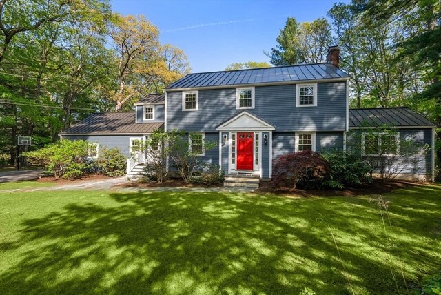 56 Arrowhead Rd, Weston, MA 02493 - colonial home with a standing seam roof, metal roof, a chimney, and a front yard