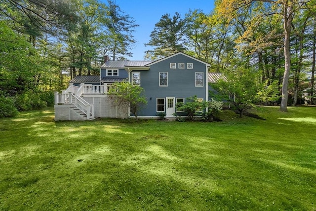 56 Arrowhead Rd, Weston, MA 02493 - rear view of house featuring stairs, a wooden deck, a yard, metal roof, and a chimney