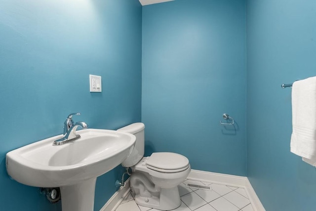 56 Arrowhead Rd, Weston, MA 02493 - bathroom with baseboards, toilet, a sink, and tile patterned flooring