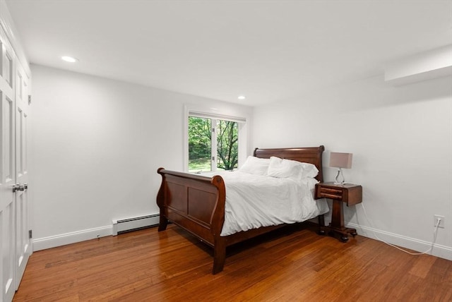 56 Arrowhead Rd, Weston, MA 02493 - bedroom featuring a baseboard heating unit, light wood finished floors, baseboards, and recessed lighting