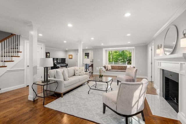 56 Arrowhead Rd, Weston, MA 02493 - living area featuring ornate columns, stairs, wood finished floors, recessed lighting, and a high end fireplace