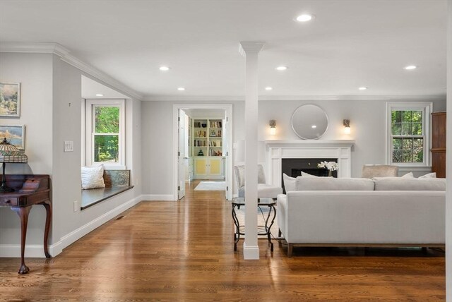 56 Arrowhead Rd, Weston, MA 02493 - living area with ornamental molding, wood finished floors, recessed lighting, baseboards, and a fireplace