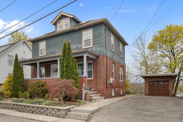 american foursquare style home with brick siding and an outdoor structure
