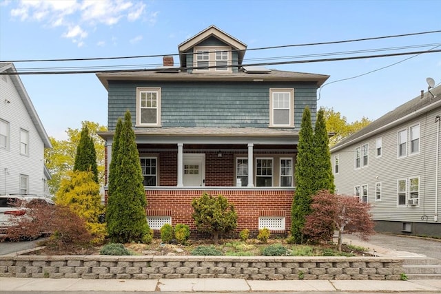 traditional style home with brick siding and covered porch