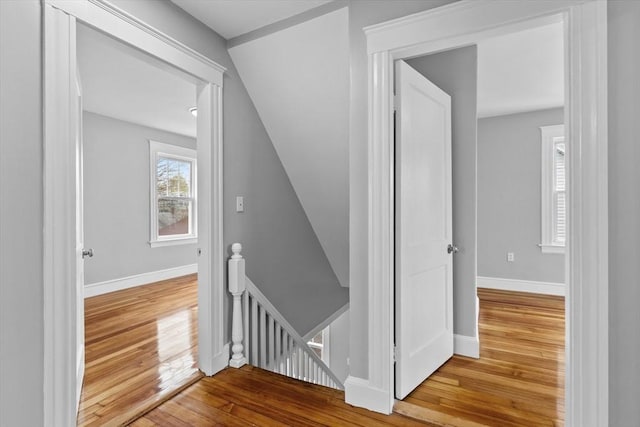 stairs featuring baseboards and hardwood / wood-style flooring