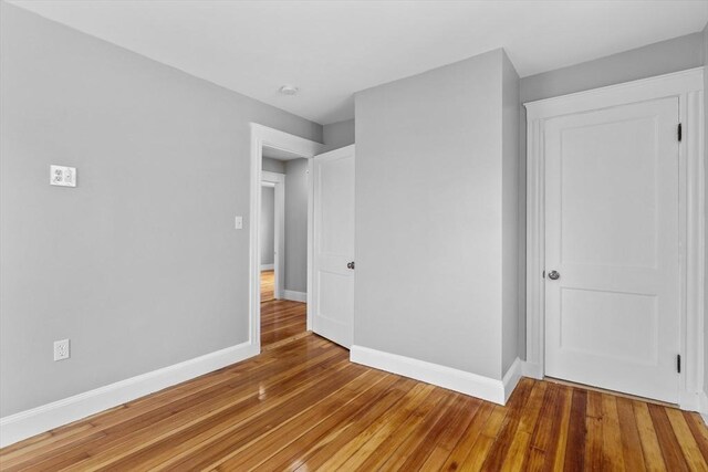unfurnished bedroom with baseboards and light wood finished floors