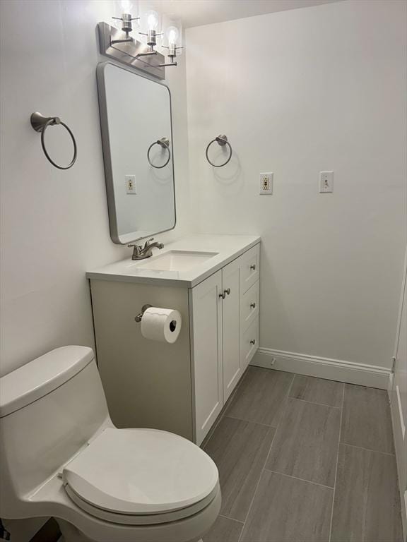 1550 Worcester Rd Unit 503, Framingham, MA 01701 - bathroom with toilet, vanity, baseboards, and wood finished floors