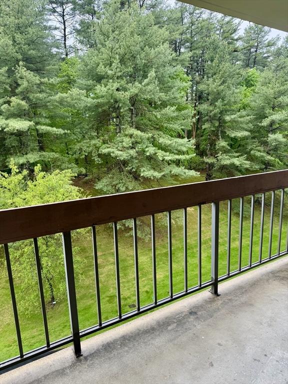 1550 Worcester Rd Unit 503, Framingham, MA 01701 - balcony featuring a forest view
