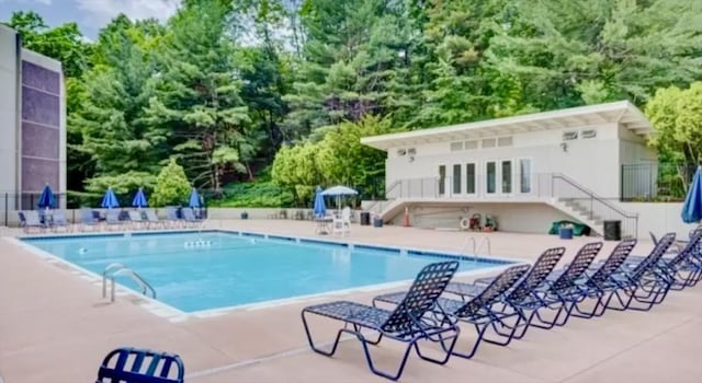 1550 Worcester Rd Unit 503, Framingham, MA 01701 - community pool with a patio area, stairs, a forest view, and fence