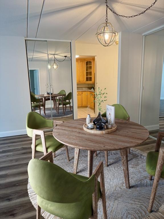 1550 Worcester Rd Unit 503, Framingham, MA 01701 - dining space with light wood-type flooring, baseboards, and a chandelier