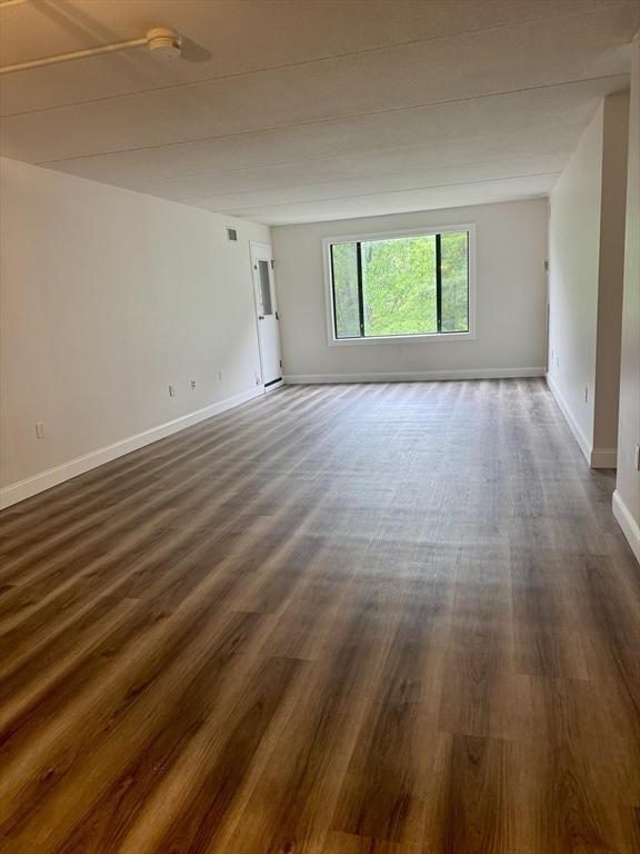 1550 Worcester Rd Unit 503, Framingham, MA 01701 - unfurnished room with dark wood-style flooring, baseboards, and a smoke detector