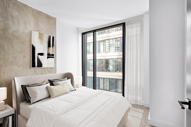 bedroom featuring a wall of windows