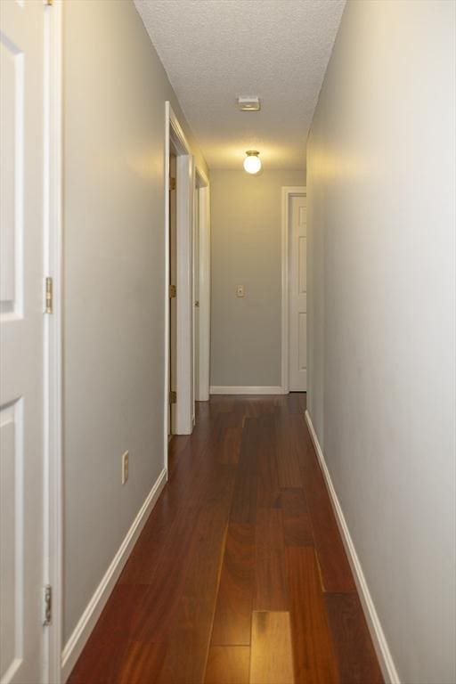 140 Heritage Dr Unit 140, Northbridge, MA 01588 - corridor with baseboards and a textured ceiling