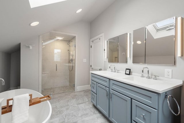 50-52 Linden Pl, Brookline, MA 02446 - bathroom featuring a skylight, a shower stall, double vanity, vaulted ceiling, and a freestanding tub