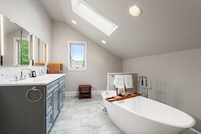 50-52 Linden Pl, Brookline, MA 02446 - bathroom featuring vaulted ceiling, healthy amount of natural light, double vanity, marble finish floors, and a skylight