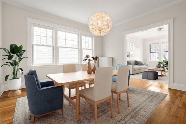 50-52 Linden Pl, Brookline, MA 02446 - dining room featuring ornamental molding, wood finished floors, baseboards, and a chandelier