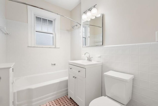 50-52 Linden Pl, Brookline, MA 02446 - full bathroom featuring toilet, vanity, tile walls, shower / tub combination, and wainscoting