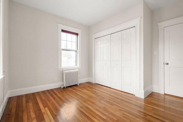 50-52 Linden Pl, Brookline, MA 02446 - unfurnished bedroom with radiator, light wood-type flooring, baseboards, and a closet