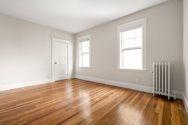 50-52 Linden Pl, Brookline, MA 02446 - spare room featuring radiator heating unit, light wood-style floors, and baseboards