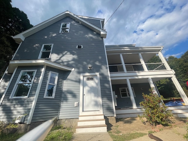 back of property with a balcony