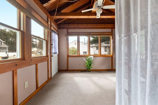 unfurnished sunroom featuring a ceiling fan and vaulted ceiling