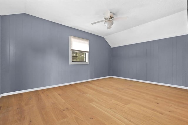 bonus room featuring vaulted ceiling, baseboards, ceiling fan, and wood finished floors