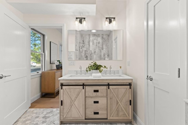354 Gifford Unit 1, Falmouth, MA 02540 - bathroom featuring double vanity, baseboards, a shower, and wood finished floors