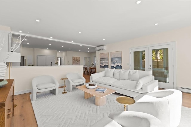 354 Gifford Unit 1, Falmouth, MA 02540 - living room with a wall mounted AC, wood finished floors, recessed lighting, french doors, and a baseboard radiator