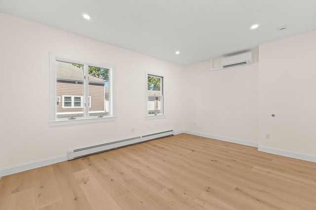 354 Gifford Unit 1, Falmouth, MA 02540 - unfurnished room featuring a baseboard heating unit, a wall mounted air conditioner, light wood-style floors, baseboards, and recessed lighting