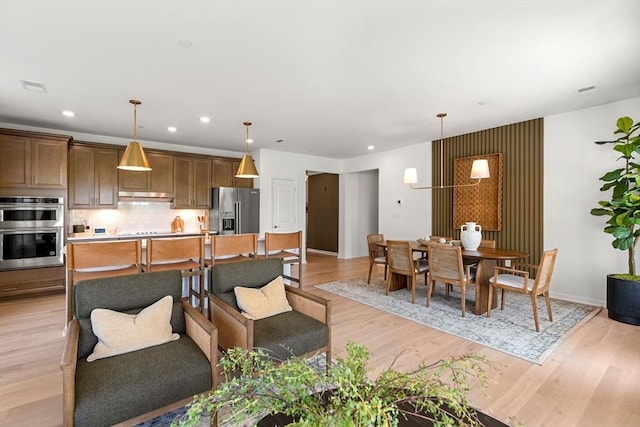 dining space with baseboards, visible vents, recessed lighting, and light wood-style floors