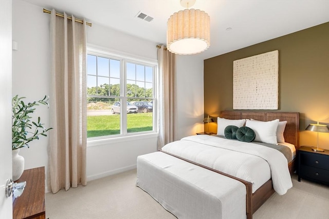 carpeted bedroom with baseboards and visible vents