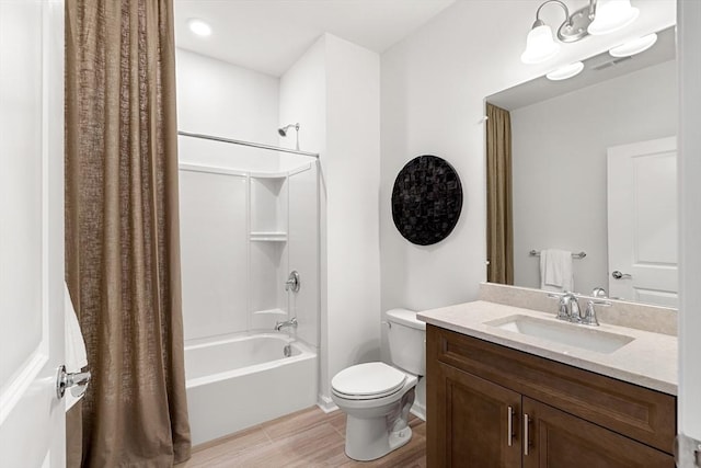 bathroom with shower / tub combo, toilet, and vanity