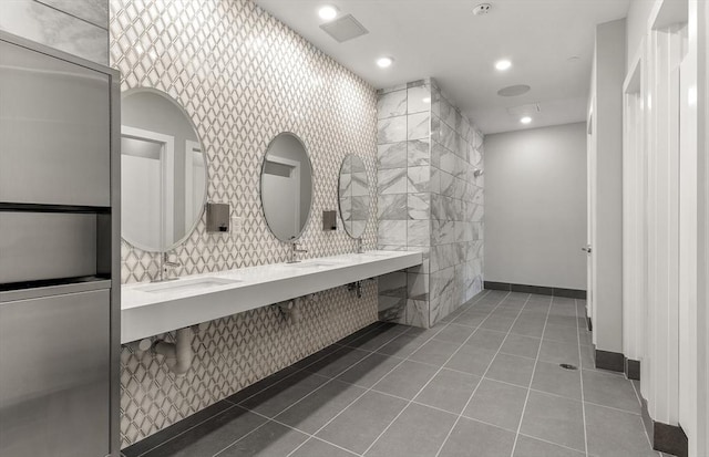 bathroom with baseboards, tile patterned flooring, a sink, and recessed lighting