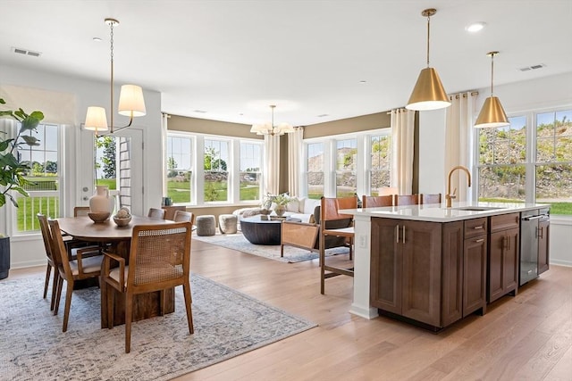 interior space with light wood finished floors, visible vents, recessed lighting, and a notable chandelier
