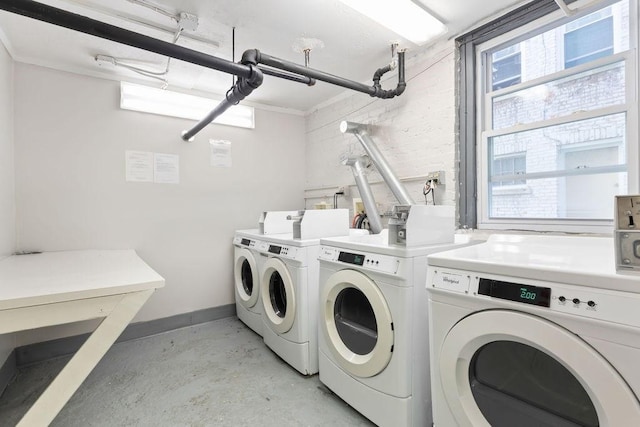 shared laundry room featuring washing machine and dryer and baseboards