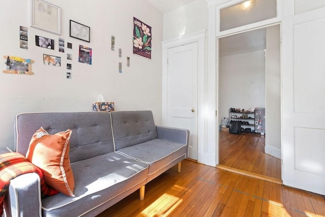 sitting room featuring hardwood / wood-style flooring and baseboards