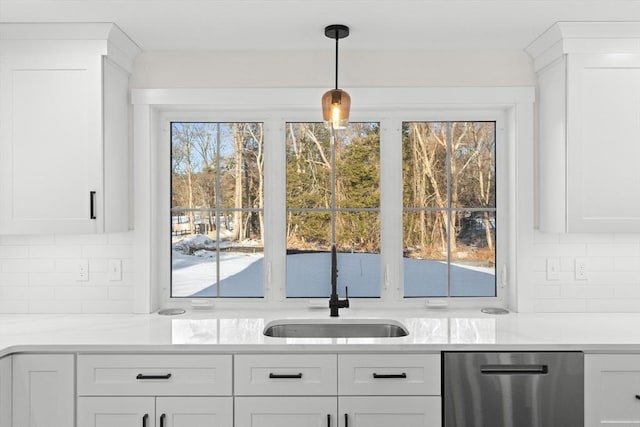 bar with sink, tasteful backsplash, dishwasher, pendant lighting, and white cabinets