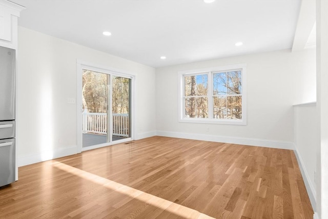 unfurnished room with light hardwood / wood-style floors