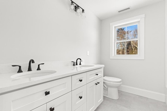 bathroom featuring vanity and toilet