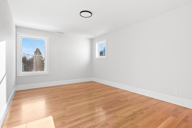 unfurnished room with light hardwood / wood-style flooring