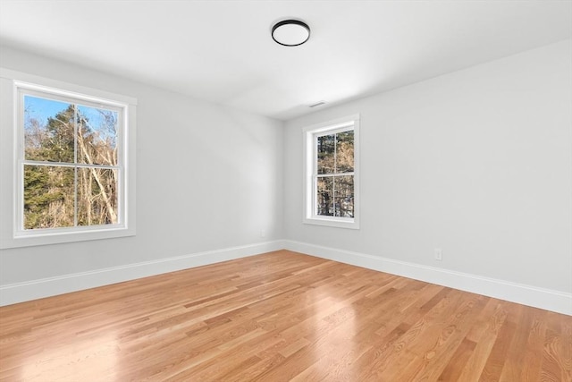 unfurnished room with light hardwood / wood-style flooring