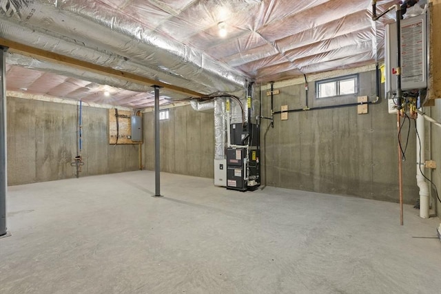 basement featuring heating unit and electric panel