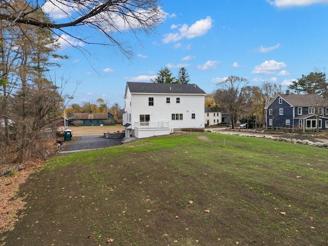 rear view of house with a lawn